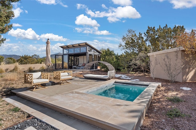 view of swimming pool featuring a patio area and an outdoor structure