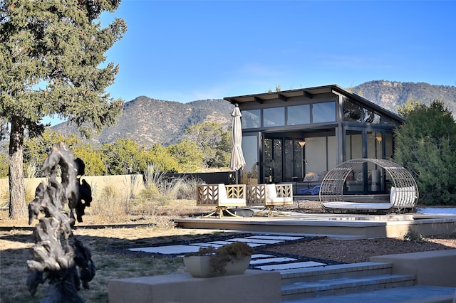 rear view of property with a mountain view