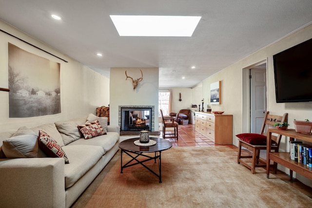 living area featuring a skylight, recessed lighting, and a multi sided fireplace