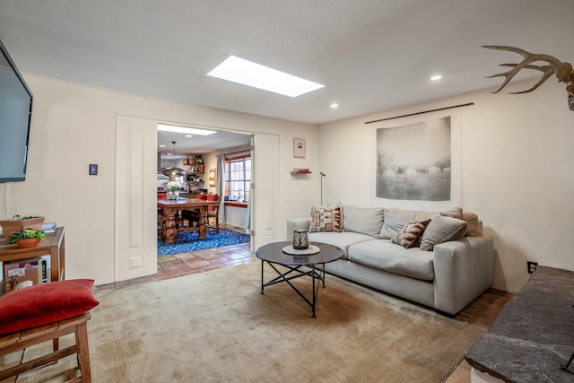 living room featuring a skylight and recessed lighting