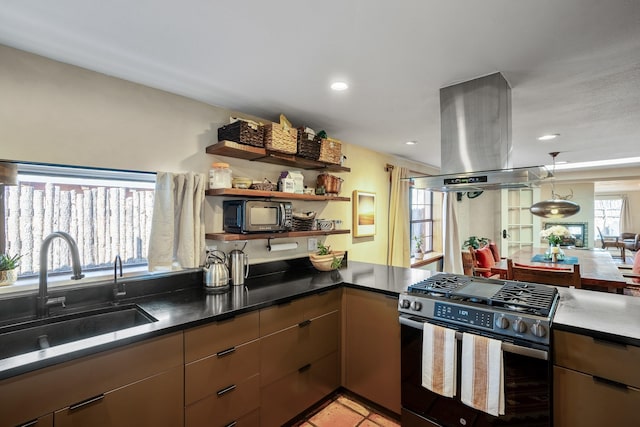 kitchen featuring island exhaust hood, open shelves, dark countertops, gas stove, and a sink