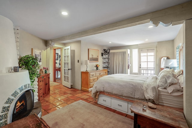 bedroom with light tile patterned floors, a lit fireplace, french doors, beam ceiling, and recessed lighting