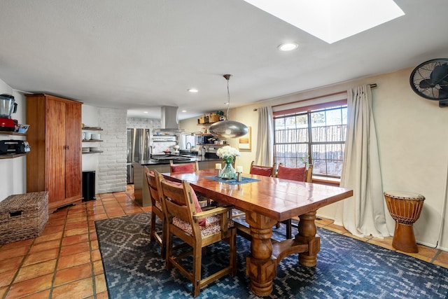 dining space featuring a skylight, light tile patterned flooring, and recessed lighting