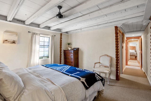 carpeted bedroom with wooden ceiling, baseboards, arched walkways, and beam ceiling