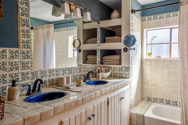 bathroom with tasteful backsplash, shower / bath combo with shower curtain, and a sink