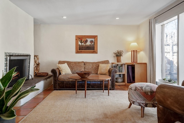 living room featuring a lit fireplace and recessed lighting