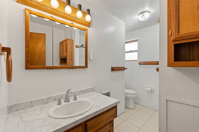 bathroom featuring tile patterned flooring, vanity, and toilet