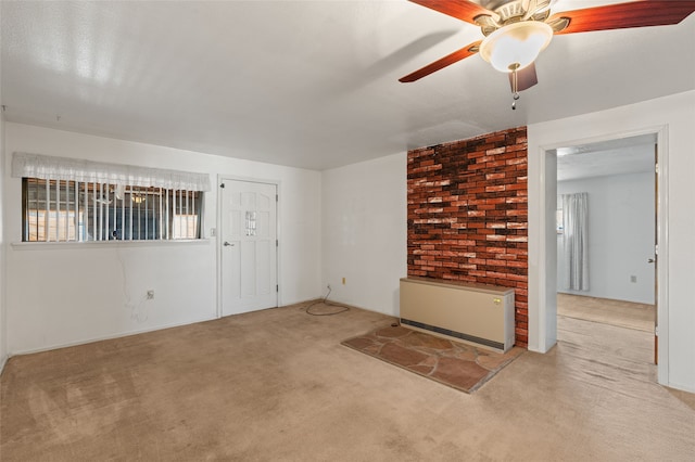 carpeted empty room with plenty of natural light and ceiling fan