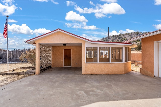 view of front of house featuring a sunroom