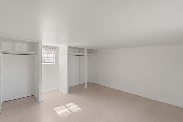 unfurnished bedroom with multiple closets