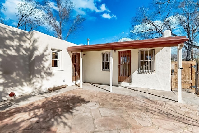 back of property with a patio