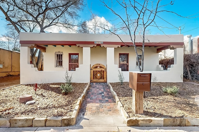 adobe home featuring covered porch