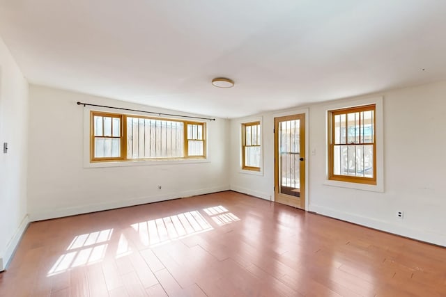 unfurnished room with hardwood / wood-style flooring