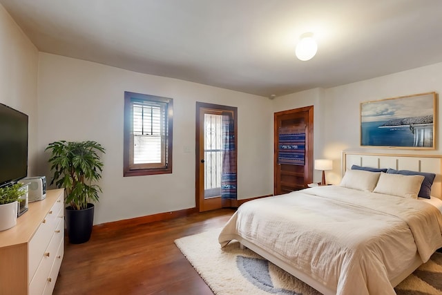 bedroom featuring dark wood-type flooring and access to exterior