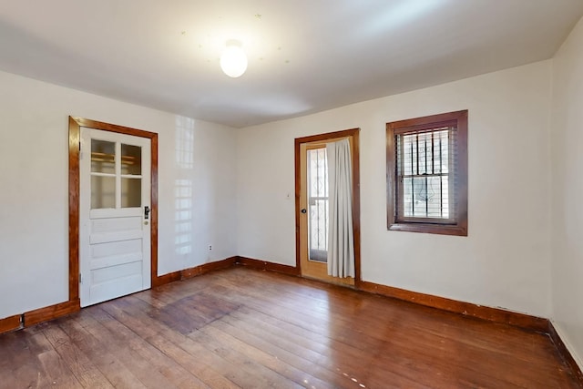 spare room with dark wood-type flooring