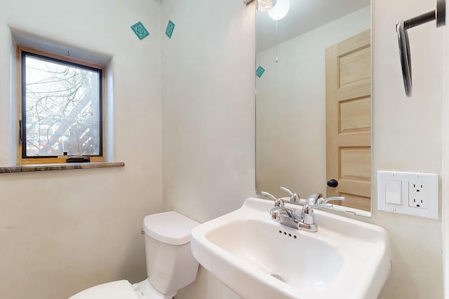 bathroom featuring sink and toilet