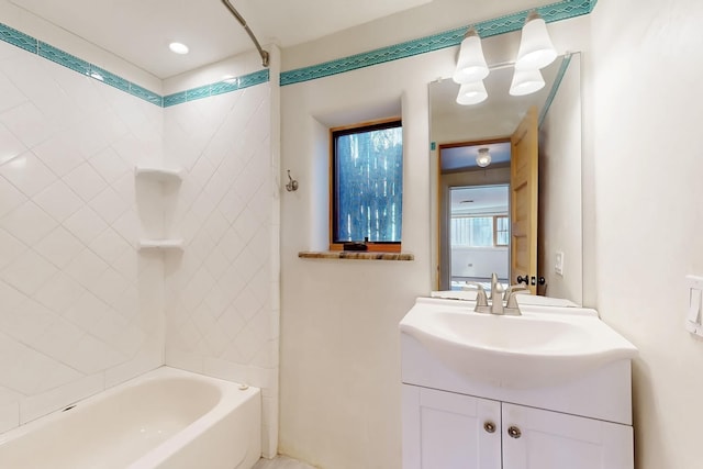 bathroom with vanity and tiled shower / bath combo