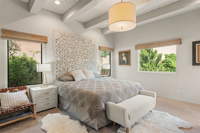 carpeted bedroom featuring beam ceiling