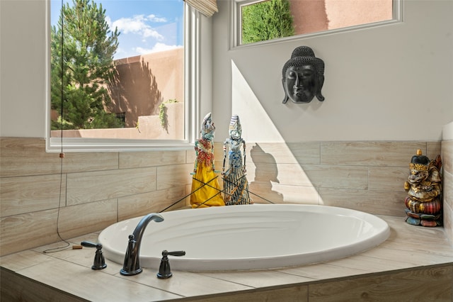 bathroom with a relaxing tiled tub