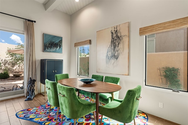 dining room featuring beam ceiling and light hardwood / wood-style floors