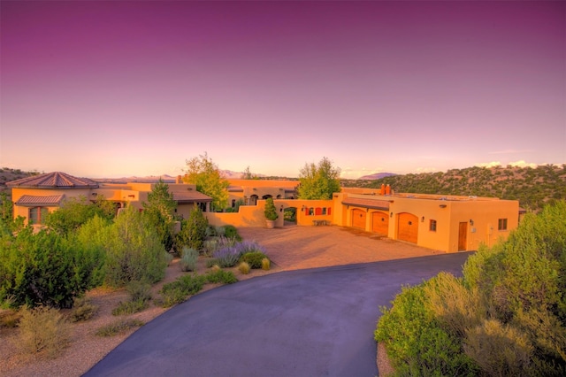 pueblo-style house featuring a garage