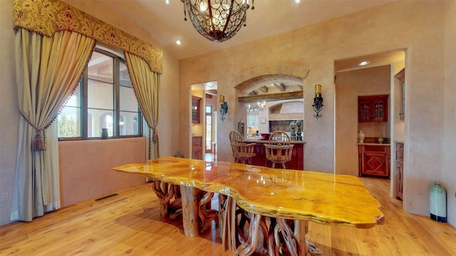 dining room featuring light hardwood / wood-style flooring and a chandelier