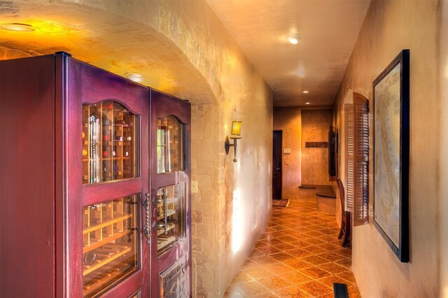 hall with tile patterned floors