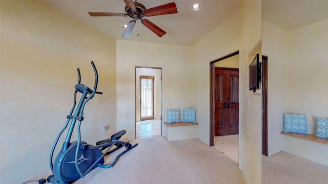 workout area featuring light carpet and ceiling fan