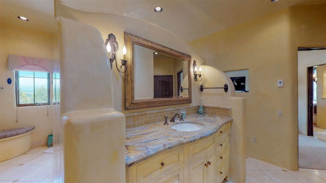 bathroom with tile patterned flooring, vanity, tasteful backsplash, and vaulted ceiling