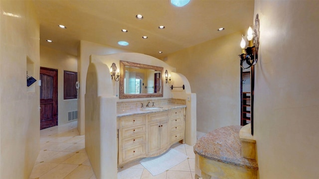 bathroom with tasteful backsplash, vanity, and tile patterned floors