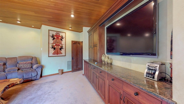 interior space featuring light colored carpet, dark stone counters, ornamental molding, and wooden ceiling