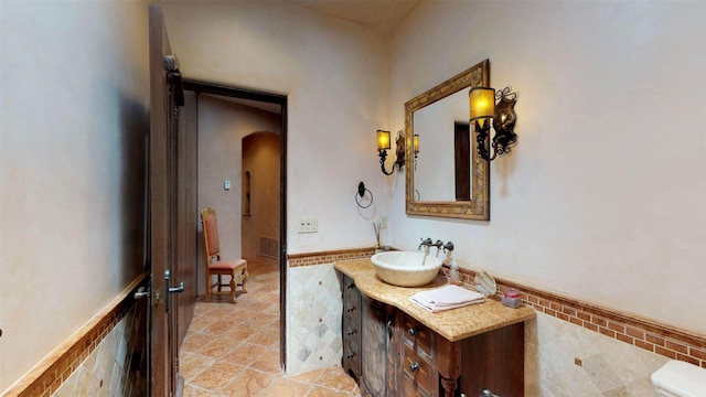 bathroom with tile patterned flooring, vanity, and toilet