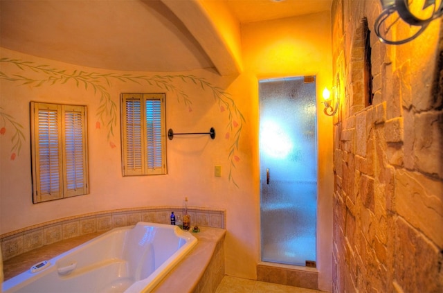 bathroom featuring tile patterned floors and tiled bath