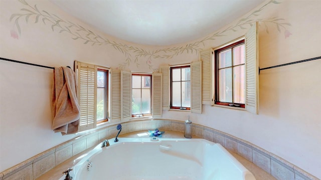 bathroom with a relaxing tiled tub