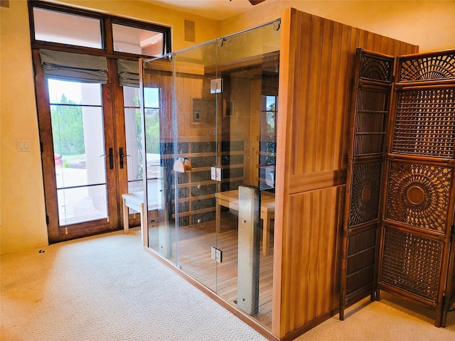 interior space with french doors and light carpet