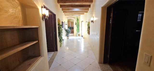 corridor featuring beam ceiling and light tile patterned floors