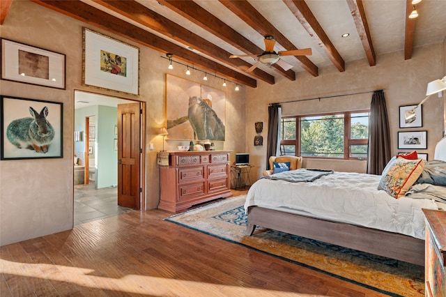 bedroom with beam ceiling and light wood-type flooring