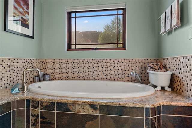 bathroom featuring tiled tub