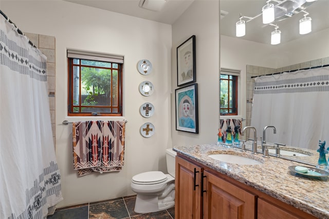 bathroom with plenty of natural light, toilet, a shower with shower curtain, and vanity