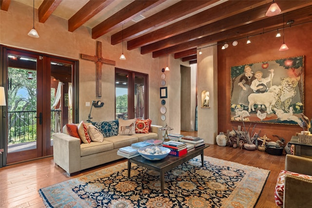 living room with hardwood / wood-style flooring, plenty of natural light, and french doors