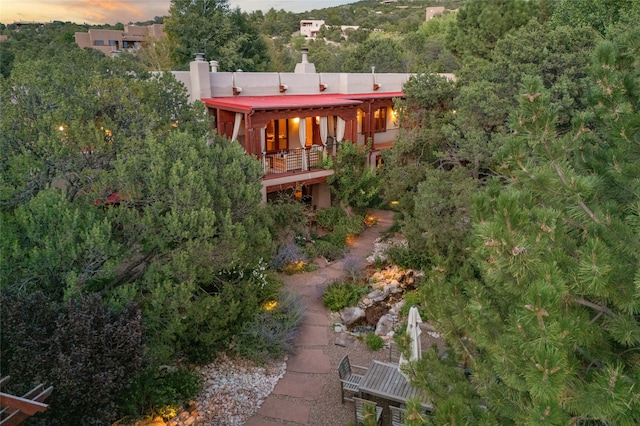 view of back house at dusk