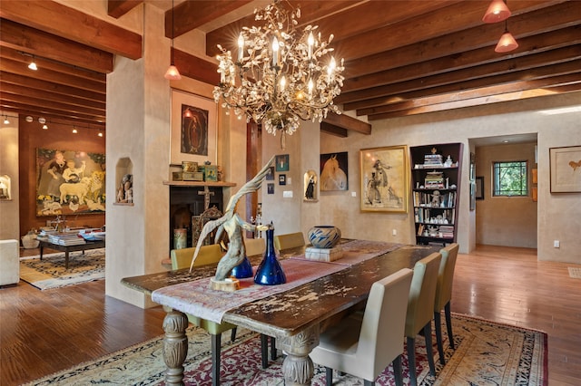 dining space with beamed ceiling and hardwood / wood-style floors