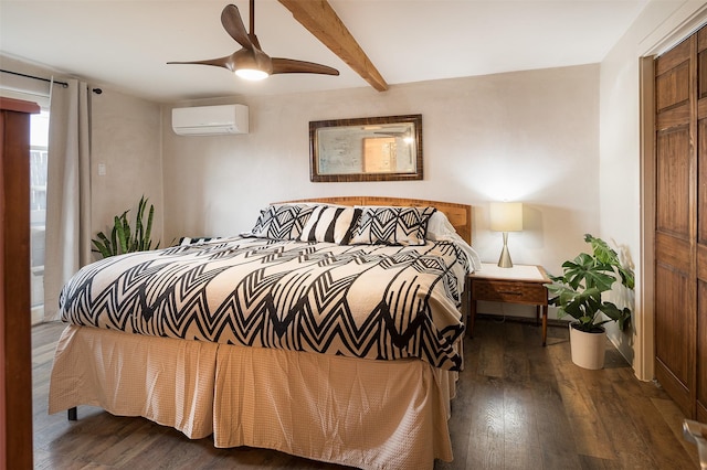 bedroom with dark hardwood / wood-style floors, a wall unit AC, ceiling fan, beam ceiling, and a closet