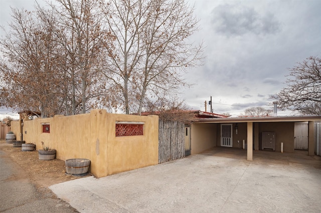 view of property exterior featuring a carport