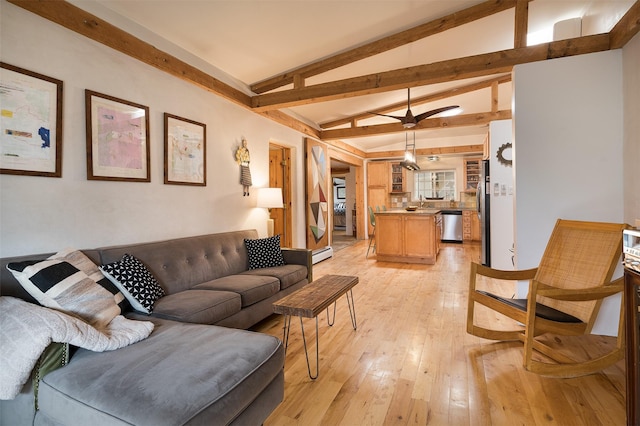 living room with lofted ceiling with beams, baseboard heating, and light wood-type flooring