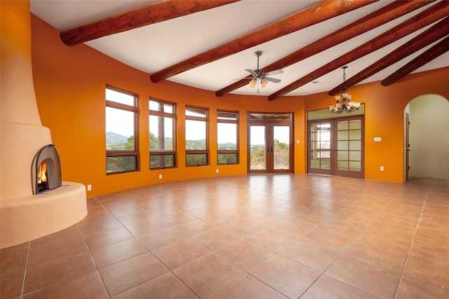 unfurnished living room with ceiling fan with notable chandelier, light tile patterned floors, beam ceiling, and french doors