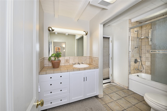 full bathroom featuring shower / bath combination with glass door, tile patterned flooring, beam ceiling, vanity, and toilet