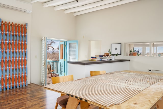 interior space featuring a towering ceiling, dark hardwood / wood-style flooring, beam ceiling, and a wall unit AC