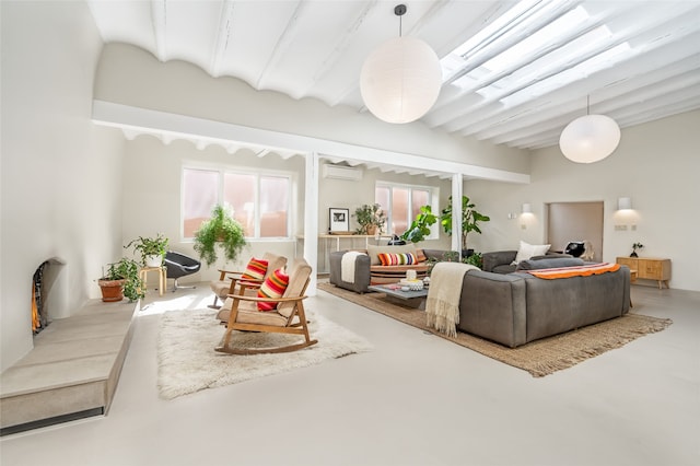 living room featuring beamed ceiling, an AC wall unit, and concrete floors