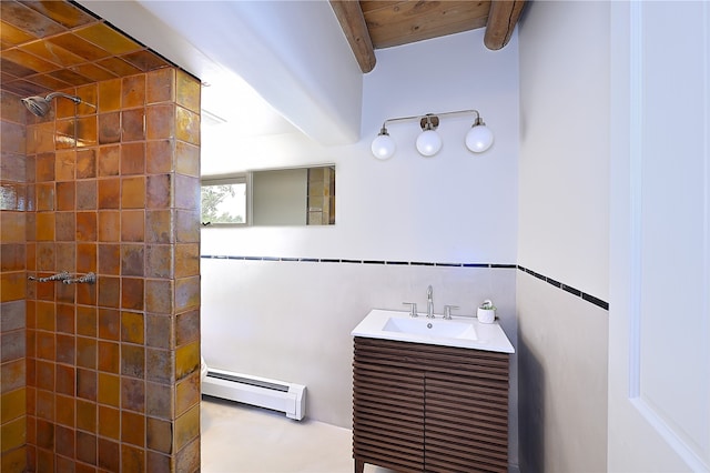 bathroom featuring beamed ceiling, a baseboard radiator, tiled shower, and vanity